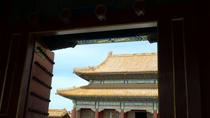 Imperial Palace Architecture Framed by a Traditional Gate in the Forbidden City, Beijing, China