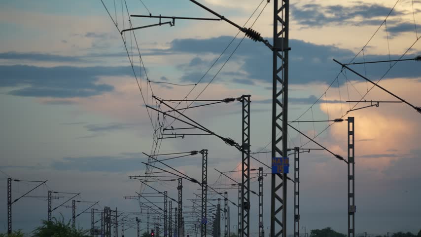 Overhead train wires amidst the autumn sunset