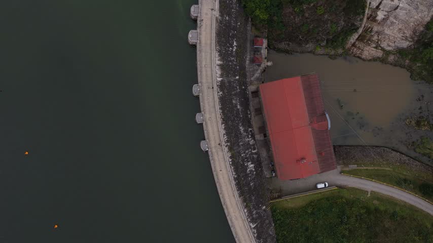 Aerial view of Zlotniki Dam with its red-roofed building and reservoir water in Zlotniki Lubanskie, Lower Silesian Voivod, Poland.