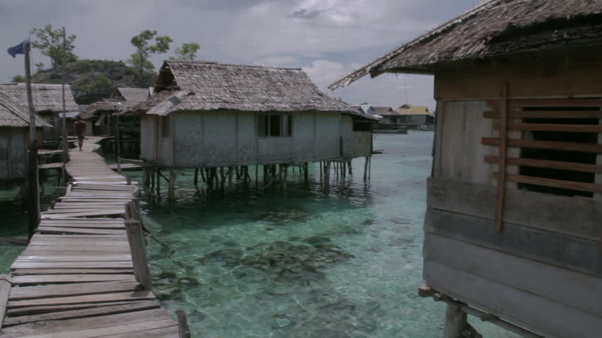 Bajo Village, Indonesia - A traditional fishing community lives in wooden houses built on stilts above the sea in the Togean Islands.

