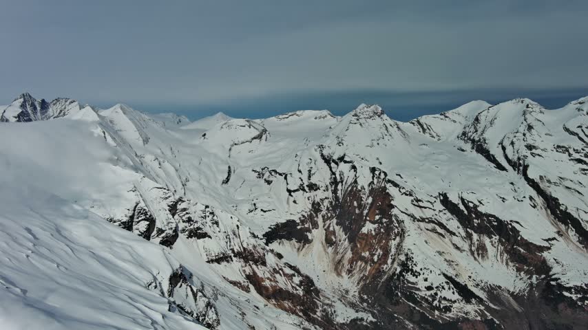 Aerial view of snow-covered mountain peaks in the Alps, Austria.