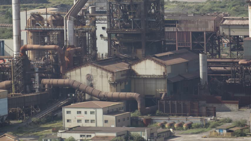Port Talbot Steelworks with Turned Off Blast Furnace with Harbour for Exports in Background.