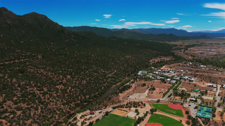 Buena Vista waterpark River Park view Arkansas River Rocky Mountains small town downtown Main Street Summer Fall morning blue sky sunny drone aerial Colorado Johnson Village forward motion