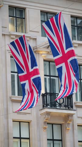 Close up shot of United Kingdom flags blowing in the wind during a national celebration in the city of London.
