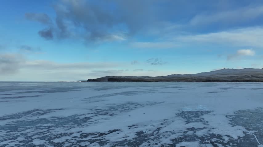 Aerial View of Low Cape on Frozen Lake Baikal at Dusk