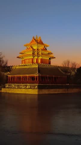 The forbidden city at sunset in Beijing,China. Corner Tower by the Lake of the Forbidden City.