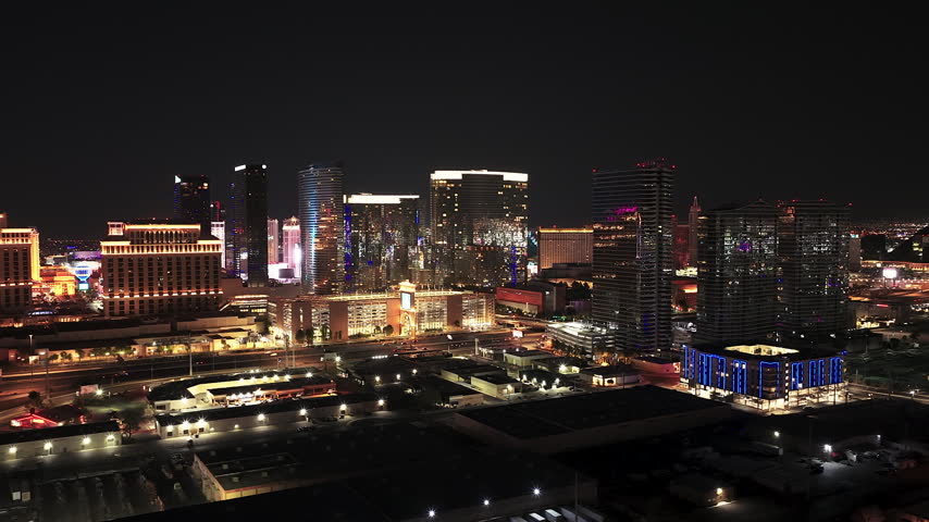 A wide aerial view of the Las Vegas strip at night featuring illuminated luxury hotels, casinos, and city traffic. Perfect for travel, tourism, and urban lifestyle content.