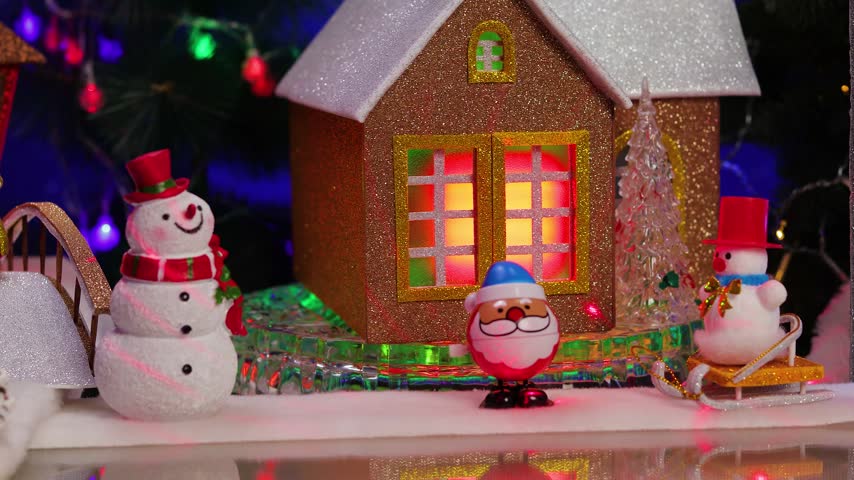 In front of the rotating house are snowmen and Santa Claus