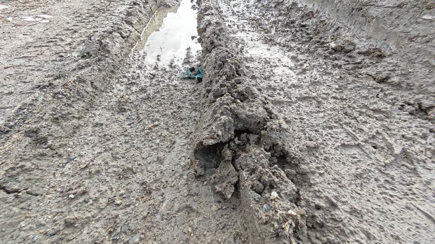 scene of the vehicle mud trail pathway into the farm.