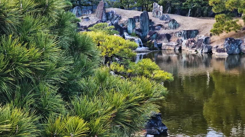 Traditional Japanese Garden in Nijo Castle Complex in Kyoto, Japan. Cascade Fall, Pond and Trees