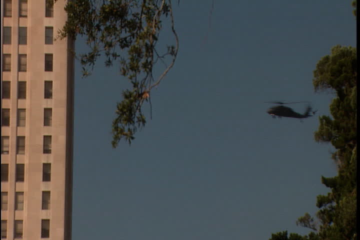 Helicopter flies behind the Art Deco tower of the Louisiana Capitol Building in Baton Rouge, Louisiana.