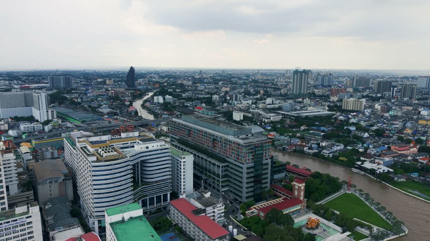 Aerial drone view of a riverside condominium tower along the Chao Phraya River in Bangkok