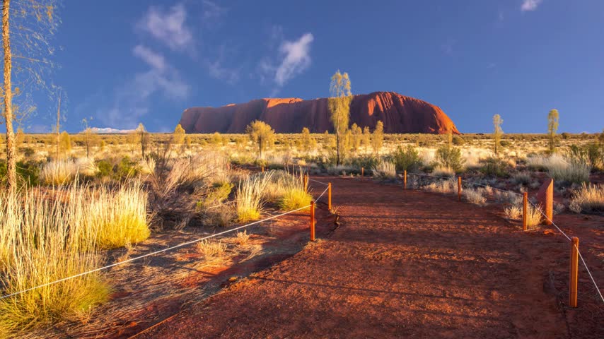 Uluru, Northern Territory, Australia - Aug 23, 2019: Vertical walls of Kantju Gorge along Uluru Mala Walk at Ayers Rock in Uluru-Kata Tjuta National Park, Red Centre. Dry season in winter blue sky.