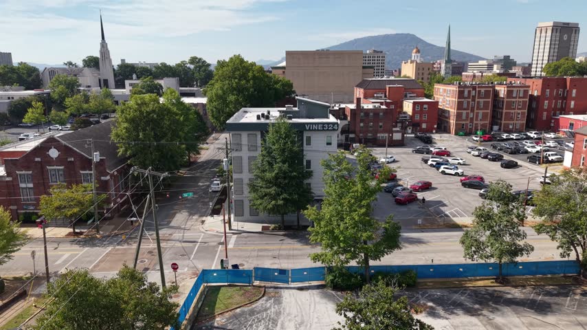 Aerial view of downtown Chattanooga Tennessee near Vine Street and Cherry Street with buildings and tree canopy below and Lookout Mountain along the skyline