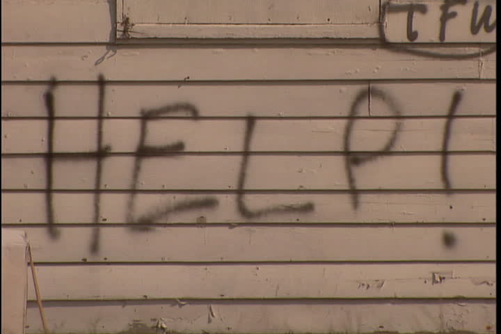 The word help! spray painted on the clapboard side of a house in New Orleans after Hurricane Katrina (October 2005).