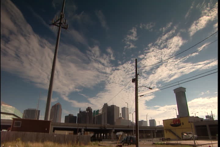 NEW ORLEANS - OCTOBER 10, 2005: Wide angle view of skyline and skyscrapers under blue cloudy sky.