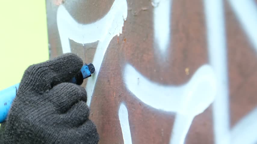 Hand writing a tag or personal signature with a marker street graffiti culture.