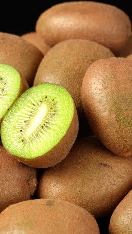 Fresh Sliced Kiwis with Whole Fruits in Background	