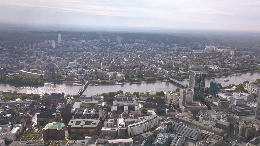 Aerial drone footage of the city and historical center and the river Main in Frankfurt am Main in Germany in the European Union. Frankfurt is the financial and banking capital of Germany and Europe.