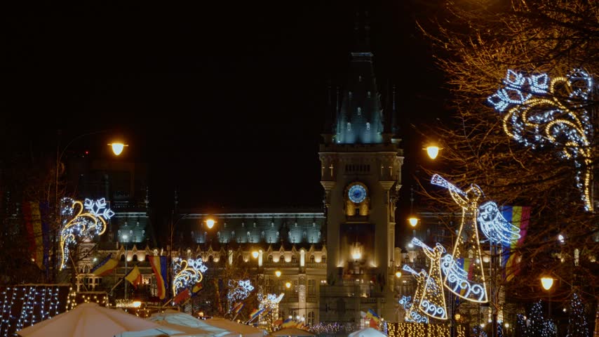 The Christmas market takes place at the Palace of Culture in Iasi. Bright lights decorate the buildings and create a festive atmosphere during the night.