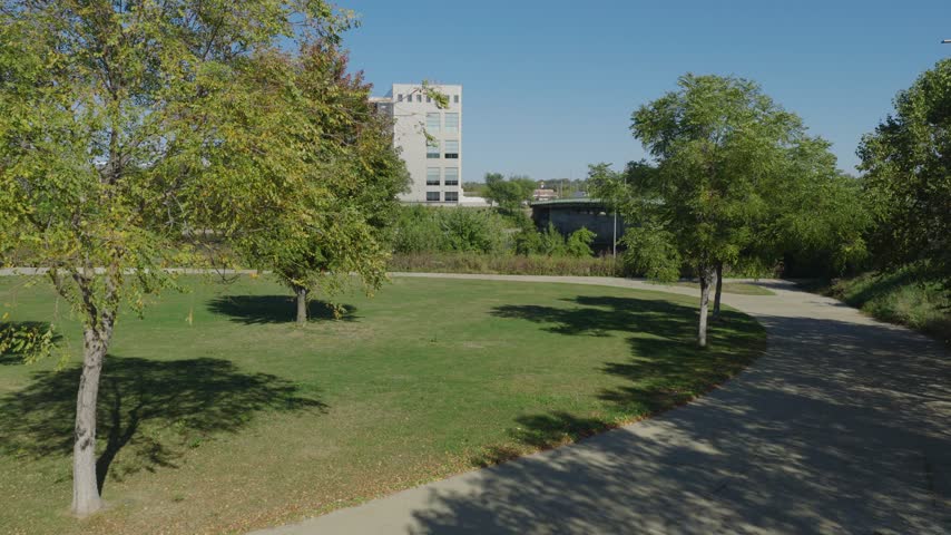 Green riverfront park with mature trees and paths in Cedar Rapids, Iowa, aerial
