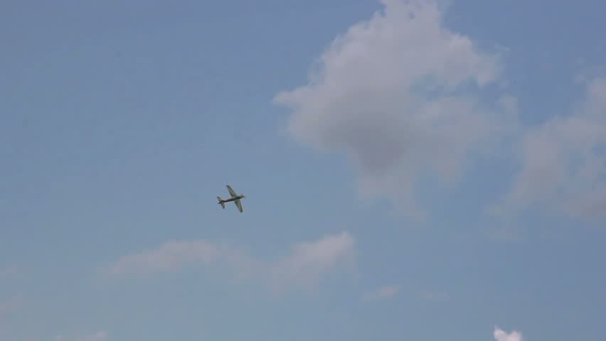 Model of the airplane flying in blue sunny sky