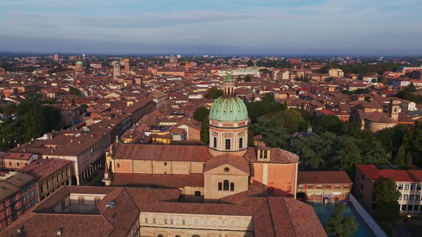 Aerial drone view of Parrocchia di San Pietro in Reggio Emilia, Italy, showcasing the historic church, elegant architecture, bell tower, rooftops, and surrounding cityscape.
