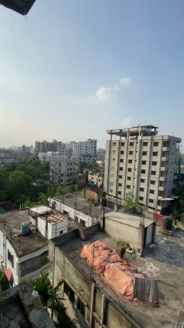 Aerial top view of residential buildings and green trees in Dhaka city Bangladesh on a sunny day, urban cityscape