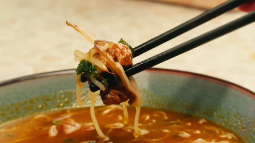 Vietnam traditional pho bo soup on delivery, Beef noodles. Pho Bo Soup with beef, rice noodles, ginger, lime, chili pepper in bowl. Vietnamese cuisine. Pho Noodle Soup restaurant Close-up.