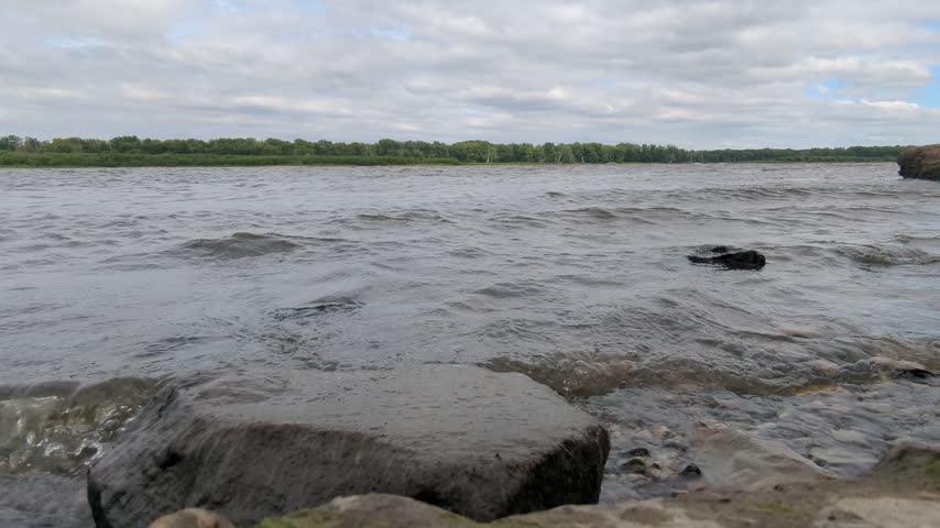 Low angle view of the waves hitting the shore on the Mississippi in Iowa looking to Illinois on a gusty fall day from Port Louisa wildlife refuge.