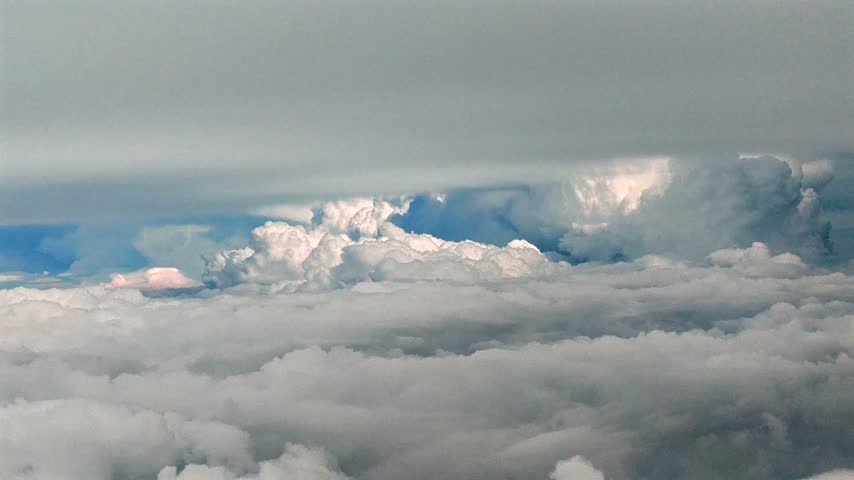 Clouds above a sea of white cumulus formations in the sky