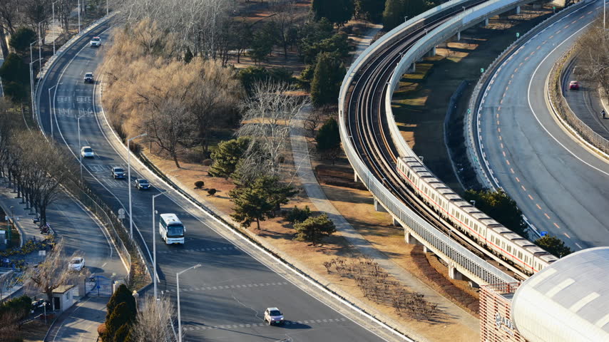 High view of a Beijing metro train on an elevated curve with traffic below