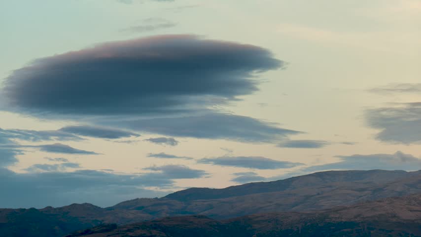 time-lapse of dark clouds sweeping over the rugged mountain silhouettes of the National Park in Portugal at nightfall.