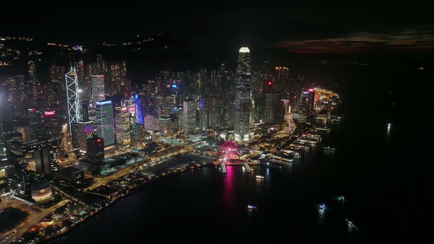 Calm night establishing shot: thousands of lights cover the island