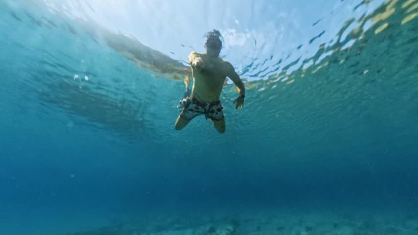 Underwater view of man swimming in transparent sea at Cala Boquer Mallorca