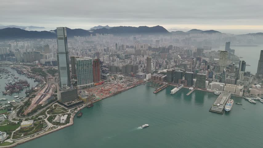 Circling the harbourfront peninsula: green park lawns meet the water beside Hong Kong