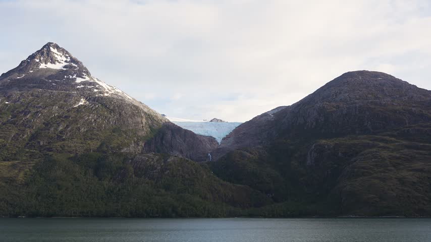 Majestic Mountain Peaks with Glacier and Calm Lake in Valley