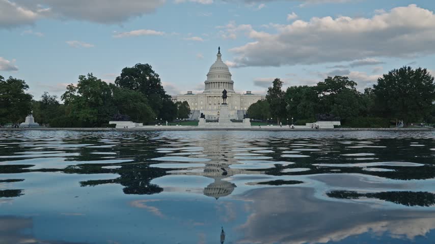 United States Capitol with pool water. Capitol across reflecting pool. Landmark Capitol and reflecting pond. Government landmark in Washington DC USA with water. Capitol reflecting pool. 4k footage