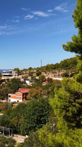 Croatia, sunny day, coastal landscape, pine trees, houses, hills