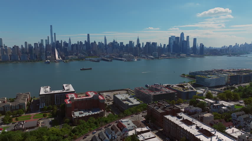 Scenic aerial view across the Hudson River toward Hudson Yards and Lower Manhattan, showcasing New York City’s waterfront skyline.