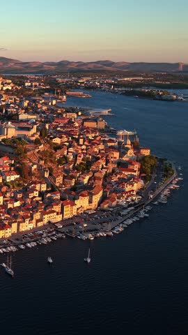 Sibenik, Croatia, aerial view of the historic coastal city, old town, marina, and Adriatic sea at sunset