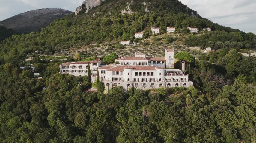 Aerial view of hillside estate below rocky peak, Nice