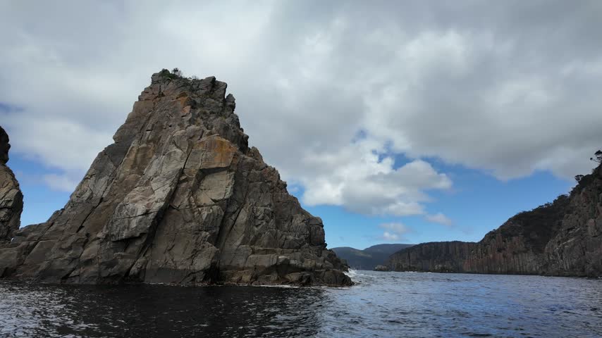 Rocky islet rising from the sea off the Tasman Peninsula coast Tasmania.
