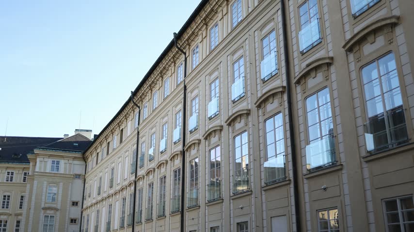 Presidential residence at Prague Castle in Czechia features an elegant historic palace facade with rows of tall windows and classical architecture overlooking a quiet courtyard