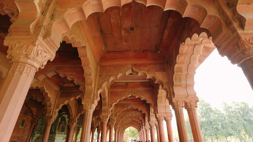 Ornate arches and columns of the ancient red fort in delhi, india, a famous landmark of mughal architecture.
