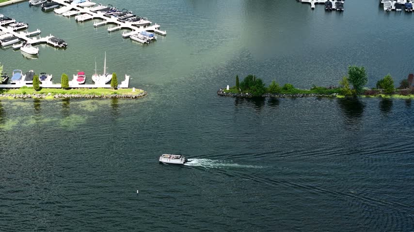 Drone View of Boat Moving in Water by Marina on Sunny Day, Lake Lawn Resort, Delavan Wisconsin USA