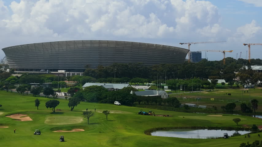 A medium shot time lapse of the Cape Town Stadium as large clouds move across the sky.