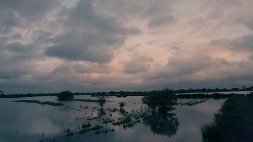 Backwaters at dawn after sunset with blue and orange sky and lake