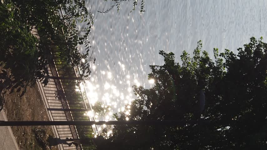 a Sunlight sparkling on the river at lunchtime on an autumn day