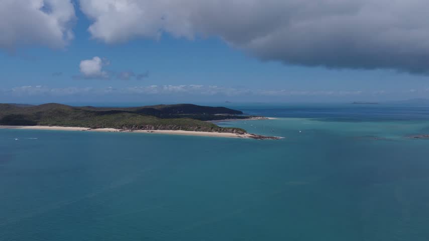 Aerial view of the Keppel Islands, featuring the coastline, turquoise waters, and lush vegetation in The Keppels, Queensland, Australia.